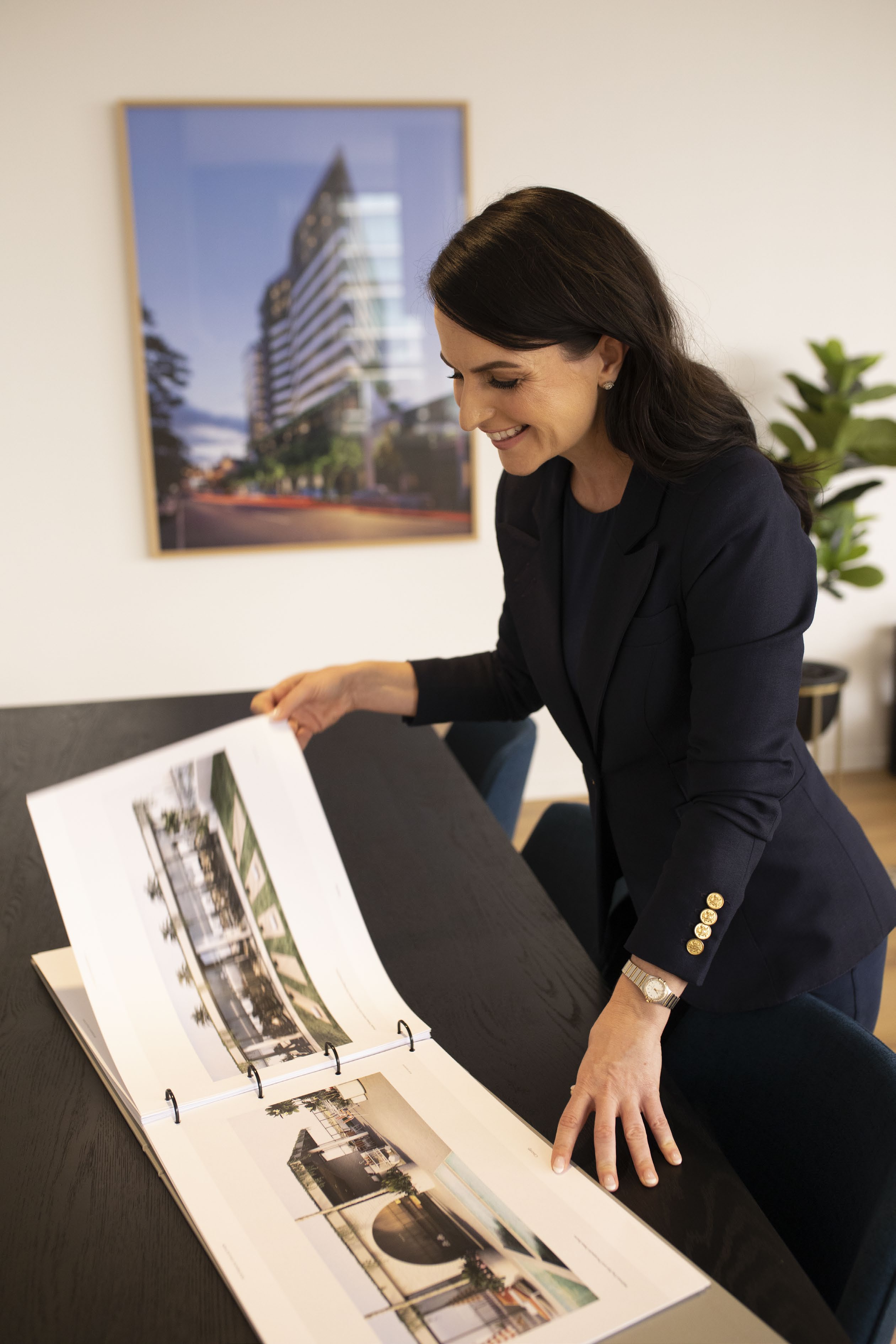 Elisa McMahon reviewing an architectural property plan